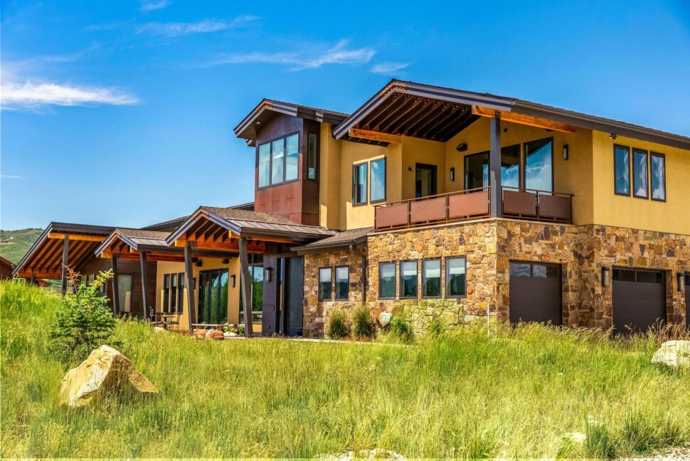 A large house with a grassy field in front of it.